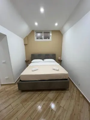a bedroom with a bed and a wooden floor at Incanto di luna Apartment in Palermo
