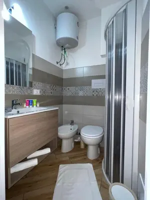 a bathroom with a toilet and a sink and a shower at Incanto di luna Apartment in Palermo