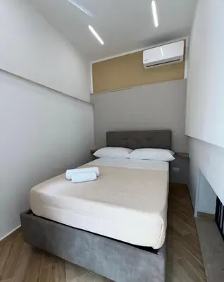 a bedroom with a bed with two white pillows at Incanto di luna Apartment in Palermo