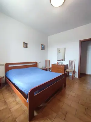 a bedroom with a bed and a table and chairs at Balestrate holiday home 70 Mq in Balestrate