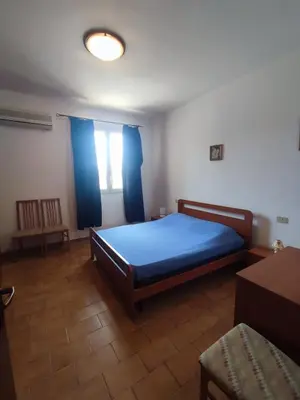 a bedroom with a blue bed and a window at Balestrate holiday home 70 Mq in Balestrate