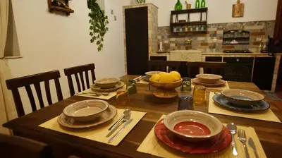 a wooden table with plates and bowls of food on it at Villa Ginevra in Balestrate