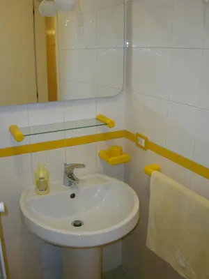 a bathroom with a white sink and a mirror at Aurora e Andrea San Vito lo Capo in San Vito lo Capo