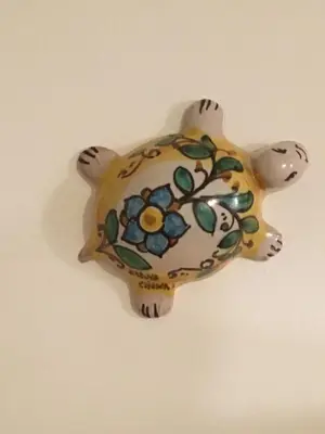 a vase shaped like a turtle hanging on a wall at Aurora e Andrea San Vito lo Capo in San Vito lo Capo