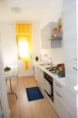 a kitchen with a sink and a stove at Casa Vacanze Ines in Carini