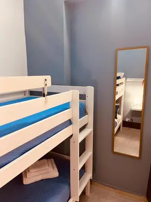a bedroom with two bunk beds and a mirror at Casa di DaFe-Casa Vacanze in Castellammare del Golfo