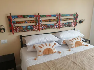 a bedroom with a bed with white sheets and pillows at Studio Florio in Palermo