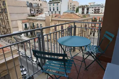 a table and chairs on a balcony with a view at Studio Florio in Palermo