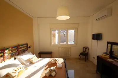a bedroom with a large bed and a window at Studio Florio in Palermo