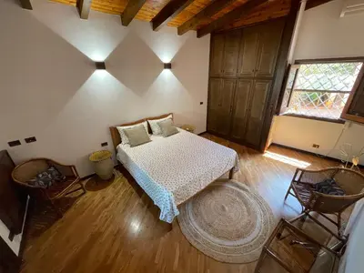 a bedroom with a bed and a large rug at Baglio Sammartano ROOM&TOUR in Castelluzzo
