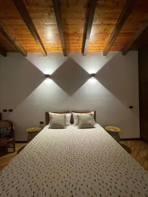 a bedroom with a large bed with two pillows at Baglio Sammartano ROOM&TOUR in Castelluzzo