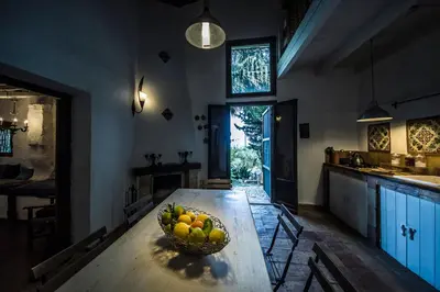 a bowl of fruit on a wooden table in a kitchen at Casa Strelizie in Terrasini