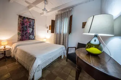 a bedroom with a bed and a lamp on a table at Casa Strelizie in Terrasini