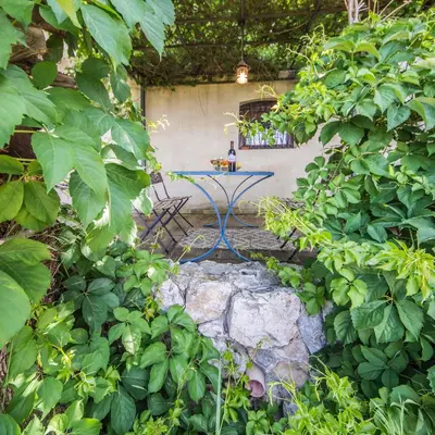 a table sitting on a rock in a garden at Casa Strelizie in Terrasini
