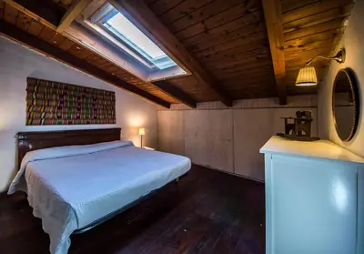 a bedroom with a bed and a mirror and a window at Casa Strelizie in Terrasini