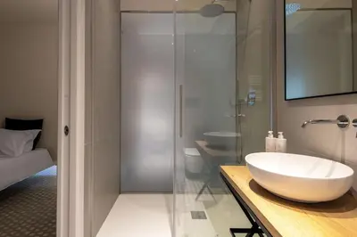 a bathroom with a sink and a glass shower at Casa Design tra le Mura by Wonderful Italy in Palermo