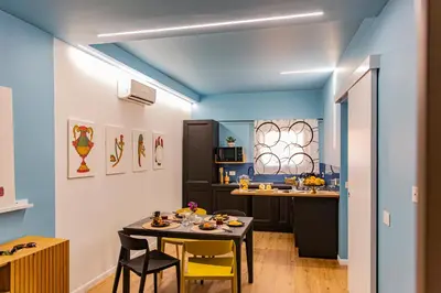 a dining room and kitchen with a table and chairs at Le Carte in Castellammare del Golfo