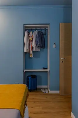a bedroom with a blue wall and a closet at Le Carte in Castellammare del Golfo