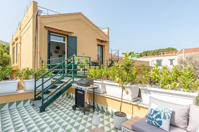 a balcony with a green staircase on a house at Villa Ammirata Mondello by Wonderful Italy in Mondello
