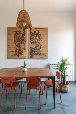 a dining room with a wooden table and red chairs at Villa Ammirata Mondello by Wonderful Italy in Mondello