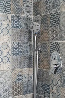 a shower in a bathroom with a tile wall at GuestHost - La Giara - Villa with Swimming Pool and Parking in Castellammare del Golfo