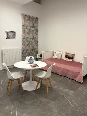 a living room with a couch and a table and tile floor at Case Vacanza ORETO in Palermo