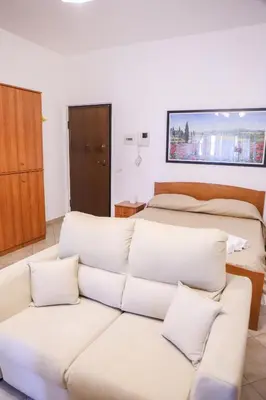 a living room with a couch and a bed at Politeama guest house Palermo Pomelia in Palermo