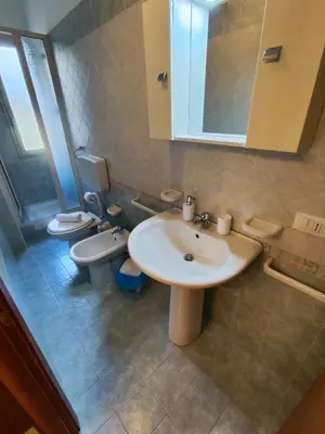 a bathroom with two toilets and a sink and a mirror at Politeama guest house Palermo Pomelia in Palermo