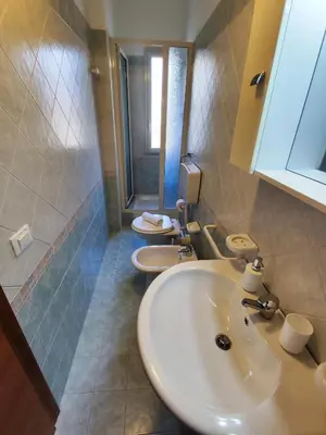 a bathroom with two white sinks and a shower at Politeama guest house Palermo Pomelia in Palermo