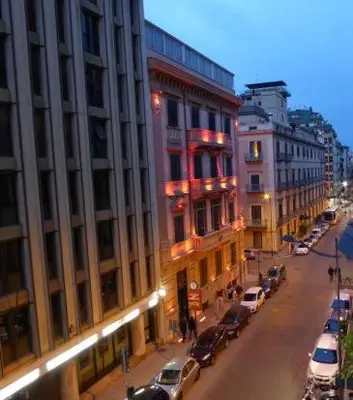 a city street with cars parked next to a building at Costanza House in Palermo