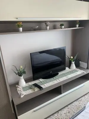 a flat screen tv sitting on a entertainment center at Costanza House in Palermo