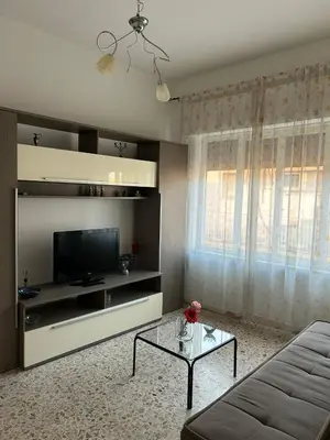 a living room with a couch and a tv at Costanza House in Palermo