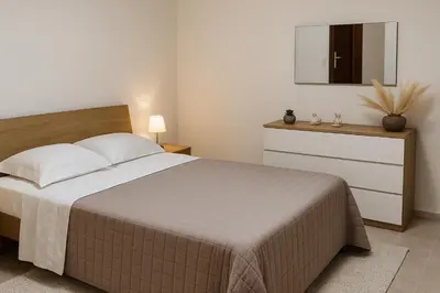 a bedroom with a bed and a dresser with a mirror at Appartamento Matteo in Trappeto