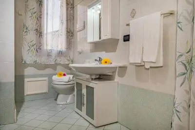a bathroom with a sink and a toilet at Casa Dolce Casa in Castellammare del Golfo