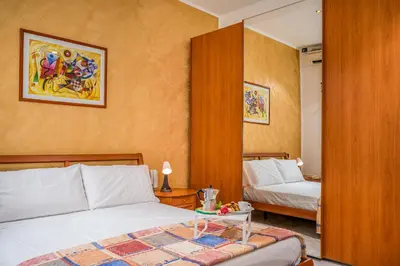 a hotel room with two beds and a table at Casa Dolce Casa in Castellammare del Golfo