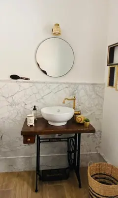 a bathroom with a sink and a mirror on a table at Donna Carmela in Porticello