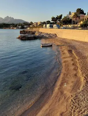 a boat sitting on the shore of a beach at Donna Carmela in Porticello