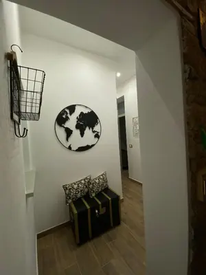 a room with a couch and a clock on the wall at Donna Carmela in Porticello