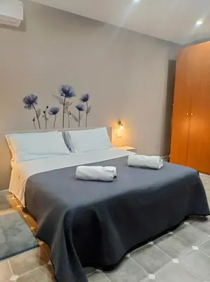 a bedroom with a large bed with two towels on it at Home SG jato in San Giuseppe Jato