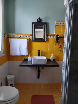 a bathroom with a sink and a mirror at Home SG jato in San Giuseppe Jato