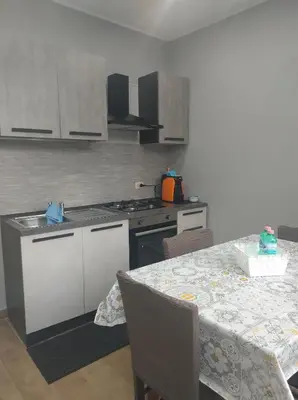 a kitchen with a table and a stove top oven at Home SG jato in San Giuseppe Jato