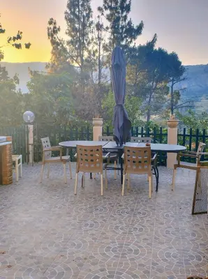 a patio with a table and chairs and an umbrella at Home SG jato in San Giuseppe Jato