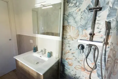 a bathroom with a sink and a shower at Isola Suite in Isola delle Femmine