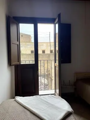 a bedroom with an open door to a balcony at Cozy 2BR in the heart of Palermo in Palermo