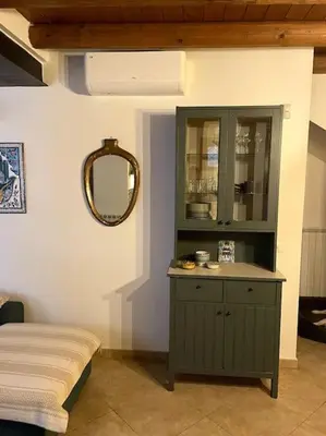 a living room with a blue couch and a kitchen at Cozy 2BR in the heart of Palermo in Palermo
