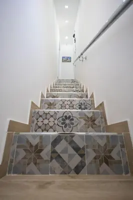 a staircase with tiled floors in a building at Mangano Suites in Palermo