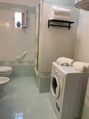 a bathroom with a washing machine and a toilet at A CASA DI GRACE in Palermo