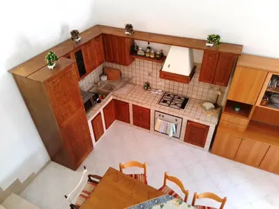 an overhead view of a small kitchen with a table at Sanvitotour - Appartamento Amaca in San Vito lo Capo