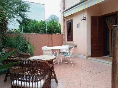 a patio with a table and chairs on a patio at Sanvitotour - Appartamento Amaca in San Vito lo Capo