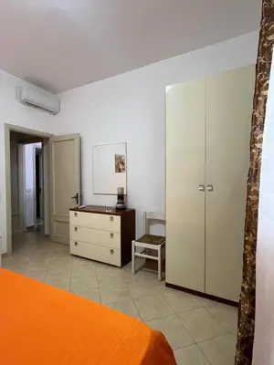 a bedroom with a bed and a dresser and a desk at Casa Finuzza in San Vito lo Capo